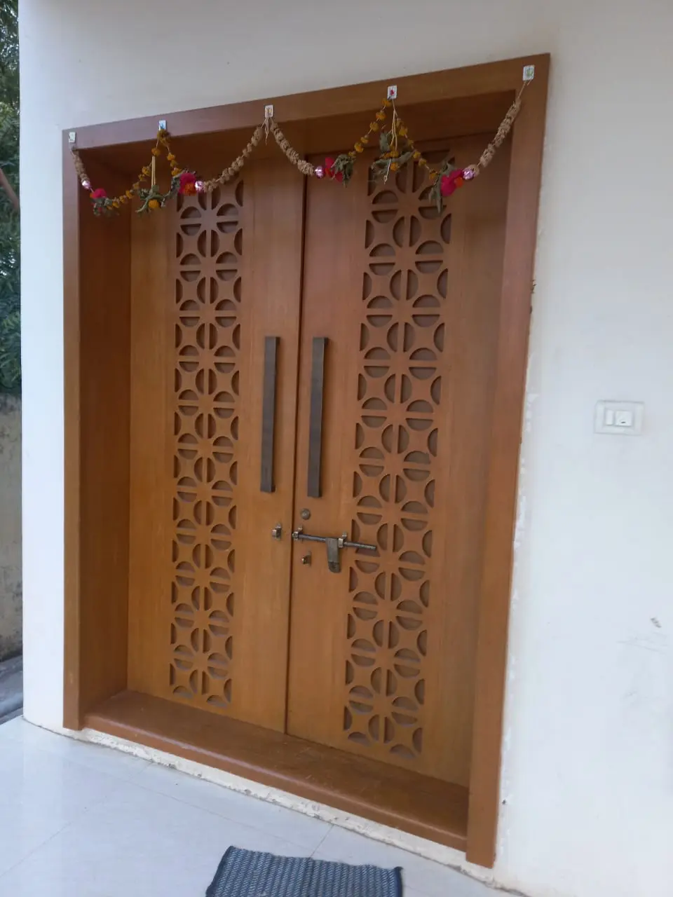 a wooden door with a floral design showing pune best interior design