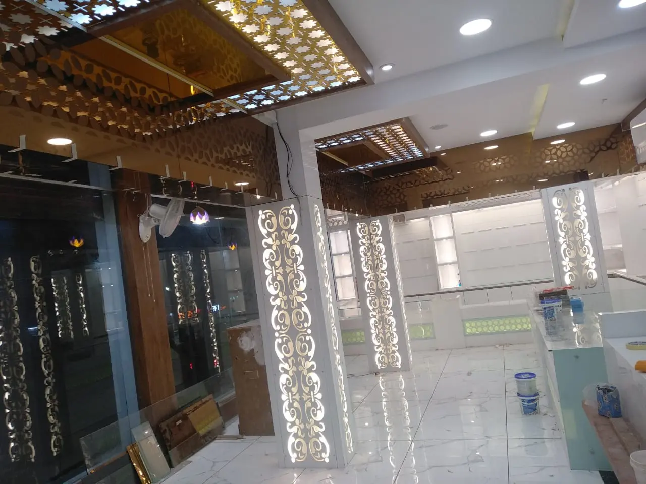 a showroom with a glass wall and a mirror showing pune best interior design