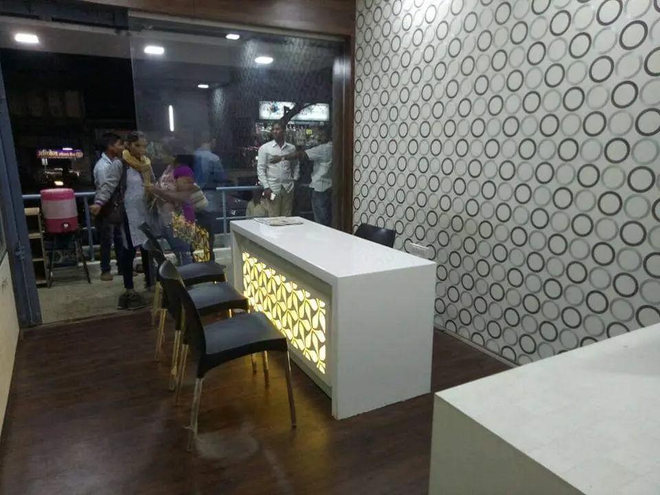 unique office table in white acrylic finish showing best interior design pune