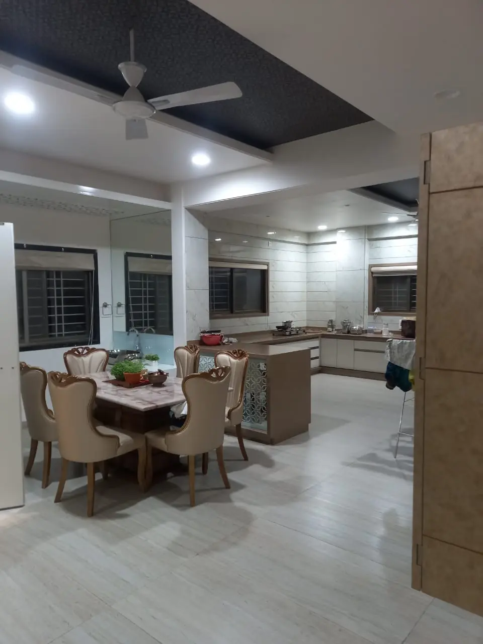 kitchen with luxurious dining table and chairs showing best interior design pune