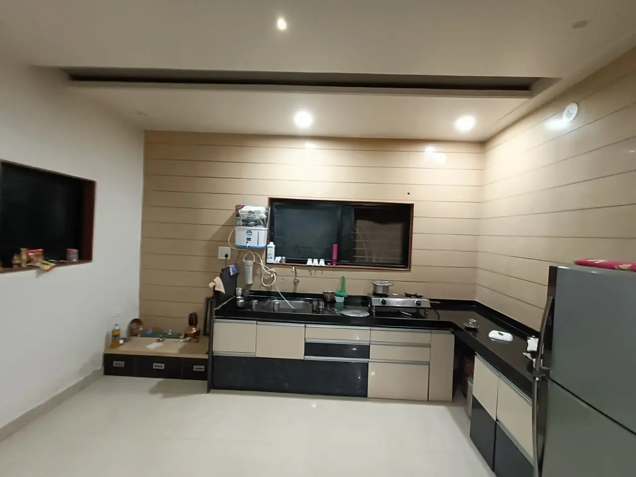 a kitchen with white cabinets and a stove showing best interior design work pune