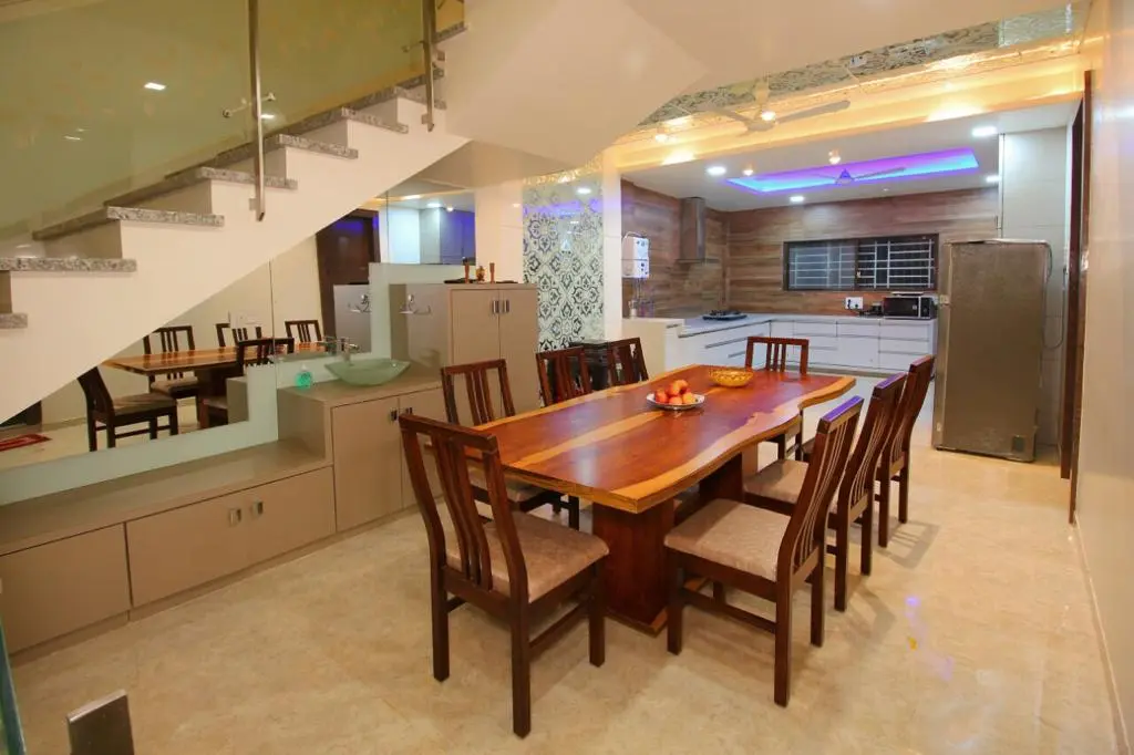 luxurious dining room with a wooden table and chairs showing best interior design pune 