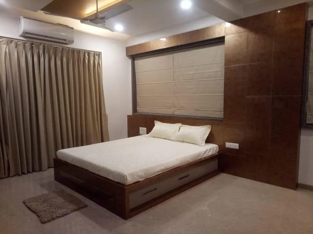 luxurious bedroom with beautiful ceiling showing best interior design pune