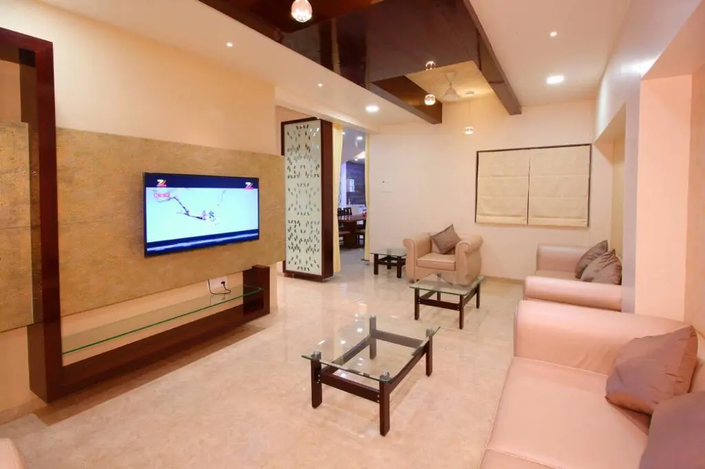 beautiful living room with a tv unit and luxurious sofa showing best interior design pune