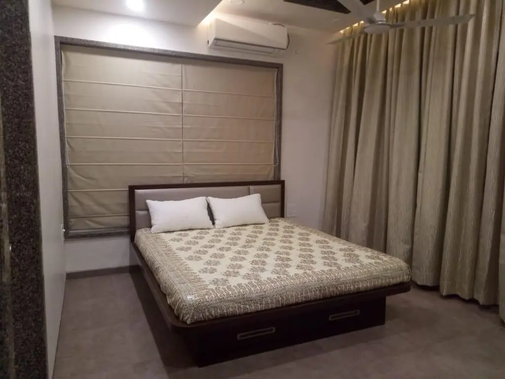 beautiful bedroom with rich curtails showing best interior design pune