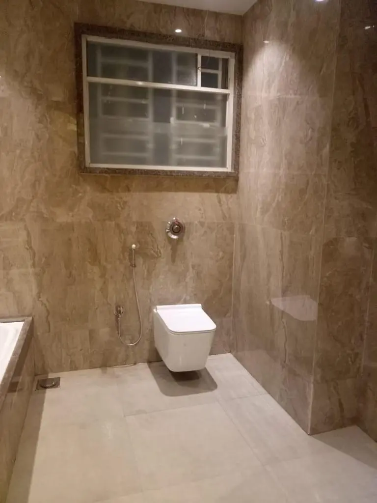 a bathroom with marble finish showing best interior design pune