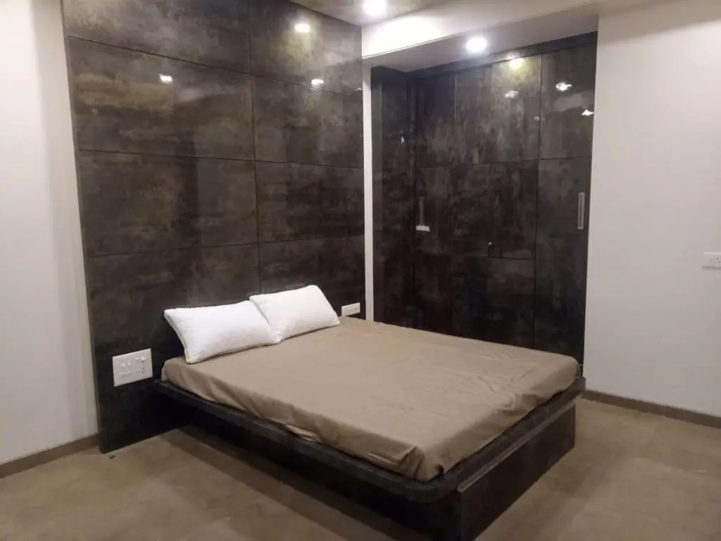 luxurious bed with a brown bedding showing best interior design pune