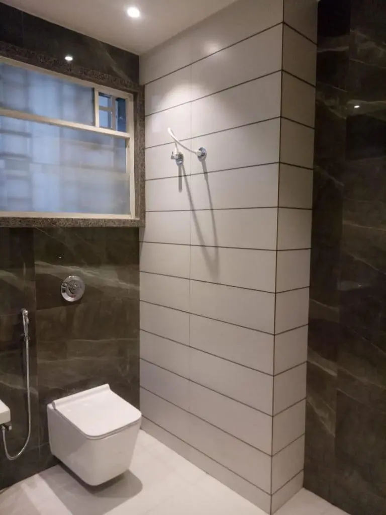 a bathroom with a toilet and shower showing best interior design pune