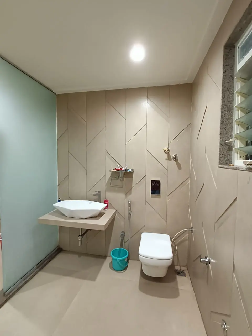 a bathroom with a sink and toilet showing best interior desgn pune