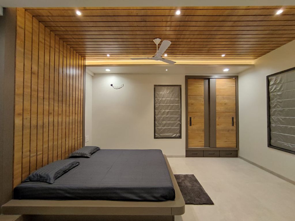 unique bed with attached headboard and ceiling showing best interior design pune